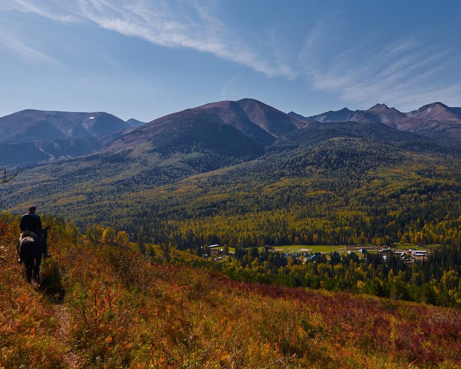 A rider on a mountain slope in autumn